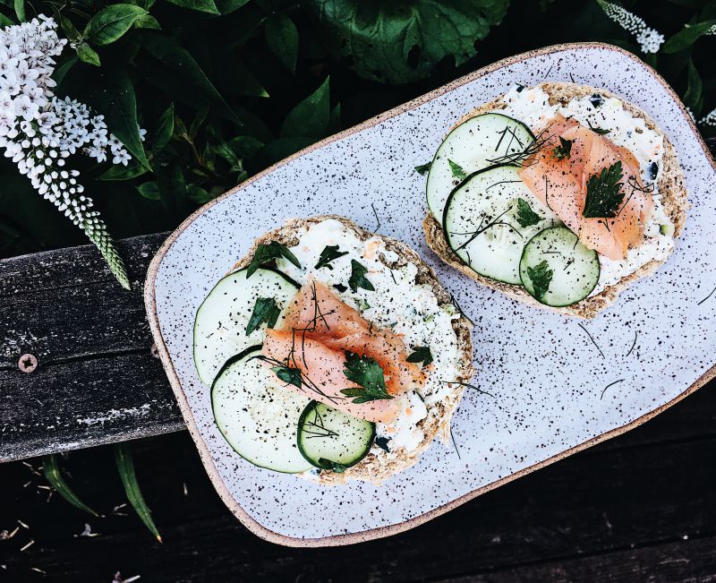 Very Veggie Smoked Salmon Bagel: Toasted Onion Poppyseed Bagel Covered with a Homemade Vegetable Cream Cheese and Topped with Sliced Cucumber, Smoked Salmon, Dill, Parsley and Black Pepper — The&nbsp;Kitchenologist©